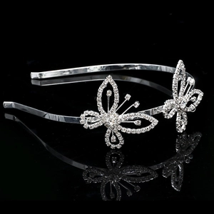 Detail of silver butterfly headband with sparkling crystals on black mirror surface