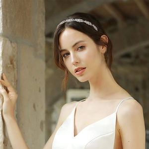 Elegant silver alloy bridal headband featuring intricate leaf rhinestone design on a model