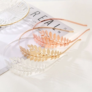 Set of three elegant leaf-shaped metal headbands in gold, silver, and rose gold finishes