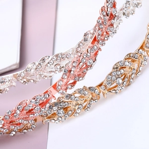 Macro detail of bridal leaf headbands in silver, rose gold and gold with crystals