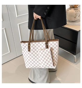 Macro view of checkered tote bag and small matching pouch with leather straps