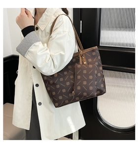 Detail of large brown tote bag with DIANMOND logo print and matching mini pouch