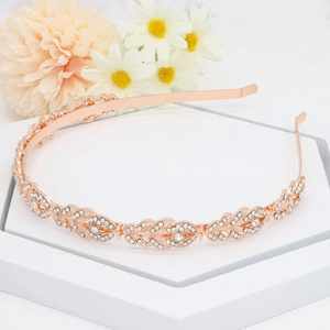 Detail of rose gold bridal headband with sparkling leaf motifs and rhinestones