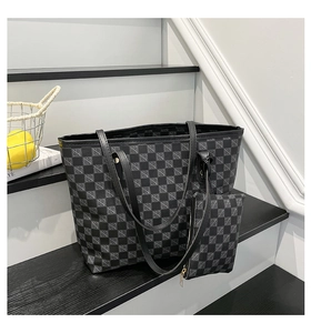 Detail of checkered tote bag and matching pouch on grey stairs in a minimalist setting