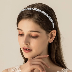 Close-up of elegant bridal headband with silver leaf design and sparkling rhinestones