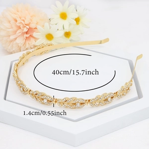 Elegant gold bridal headband with sparkling rhinestone vine leaves on a white stand