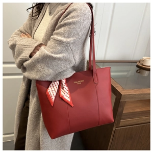 Red leather tote bag with silk scarf detail styled with a long grey knit sweater