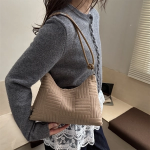 Khaki geometric embossed hobo bag with knotted strap detail for winter commuting style