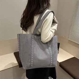Grey suede tote bag with silver studs and large capacity for winter 2025 fashion