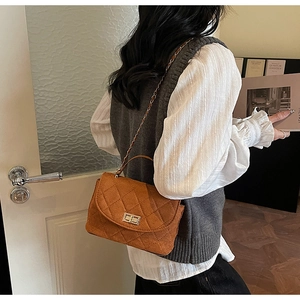 Brown quilted crossbody bag featuring retro chain strap and elegant metal twist lock detail