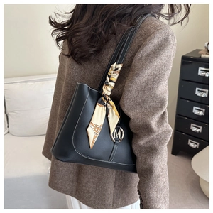 Detail of black PU leather tote bag with white contrast stitching and silk scarf wrap
