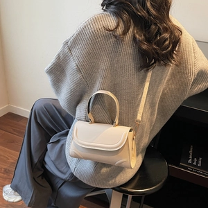 Chic off-white PU leather crossbody bag for women featuring a sleek minimalist design