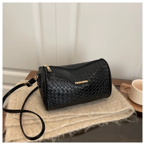 Détail du sac polochon tressé noir avec logo et finitions en métal doré brillant