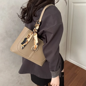Chic khaki tote bag with printed silk scarf handle and metal M detail on shoulder strap