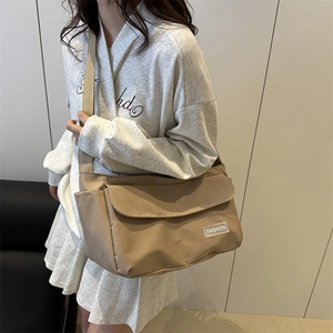 Minimalist large khaki tote bag with flap closure and adjustable shoulder strap for women