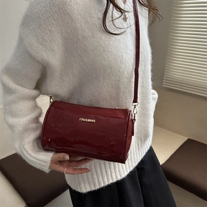 Sac cylindrique en cuir verni bordeaux brillant avec lettrage FASHION métallique