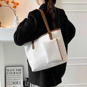 Minimalist white woven tote bag with brown straps and matching small pouch