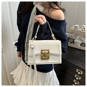 Detail view of white leather crossbody bag with vintage gold metal H buckle and top handle