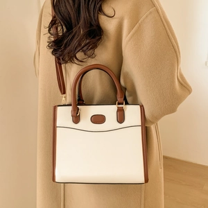 Chic two-tone tote bag in cream and brown PU leather with sleek round handle
