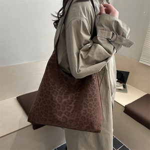 Vintage leopard print large tote bag worn with a khaki trench coat for winter style