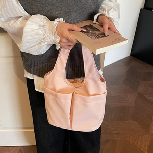 Light pink nylon tote bag with large double front pockets and spacious storage for women