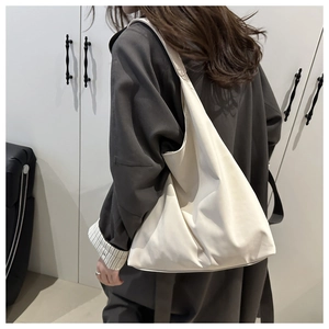 Detailed view of the large white minimalist tote bag showing soft texture and spacious design