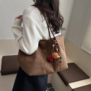 Vintage brown suede tote bag for women with decorative fur pompom and bead charm detail