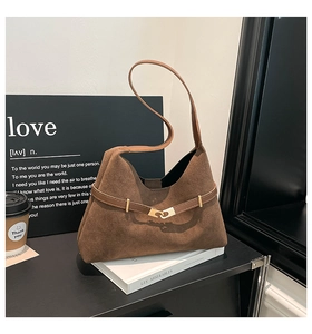 Detailed view of the brown suede tote bag with golden ring buckle and textured finish