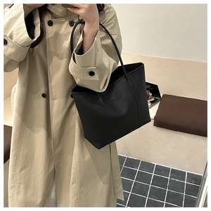 Detailed shoulder view of a black pebble leather tote bag with large capacity for women