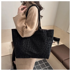 Side view of large leopard print tote bag on shoulder, ideal for daily commute use