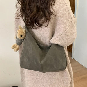 Minimalist olive green oversized tote bag in faux suede with plush bunny pendant