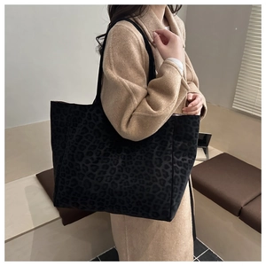 Detail shot of black leopard print tote bag with soft matte texture and large capacity