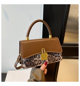 Detail of retro crossbody bag with leopard print, brown leather flap and gold clasp