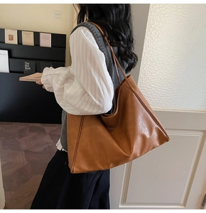 Detailed view of the caramel brown tote bag showing its large capacity and leather texture