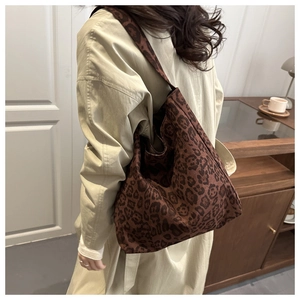 Close-up of leopard print tote bag with a soft hobo style design and integrated shoulder strap
