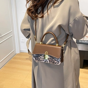 Retro leopard print shoulder bag with gold padlock clasp shown in a stylish side view