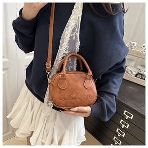 Brown faux leather mini crossbody bag with embossed lettering and gold hardware detail