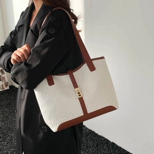 Contrast color tote bag with white crocodile pattern and brown leather trim on model