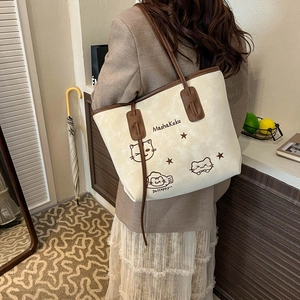 Retro minimalist cream tote bag with hand-drawn cat print and brown shoulder straps