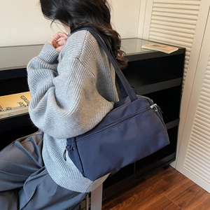 Minimalist deep blue nylon tote bag for women featuring waterproof fabric and zipper closure