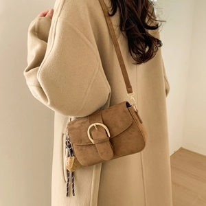 Vintage dark brown matte suede shoulder bag with gold buckle and dice pendant detail