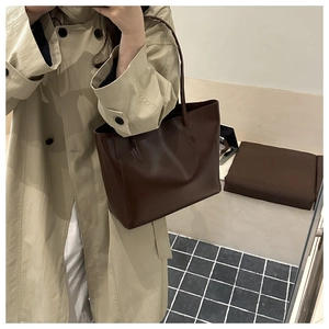 Mirror reflection showing a dark coffee tote bag paired with a classic beige trench coat