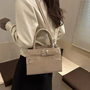 Chic beige leather handbag with silver buckle and crossbody strap for daily commute