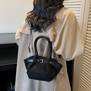 Retro black suede handbag for women featuring a minimalist trapezoid design and metal buckle