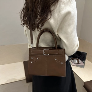 Minimalist large brown leather shoulder bag with silver buckle and crossbody strap