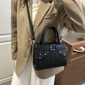 Chic black faux leather handbag with buckle detail and crossbody strap for women