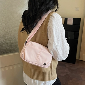 Pink nylon crossbody shoulder bag for women with wide strap and zip closure