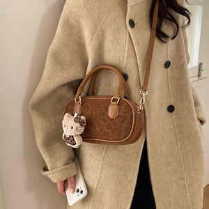 Brown leopard print Boston bag with twin handles and cute plush charm detail