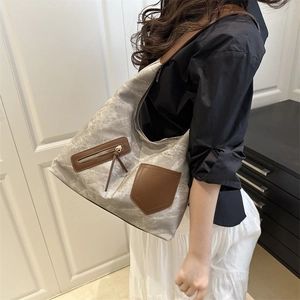 Large gray canvas tote bag with brown leather details for women commuting in style