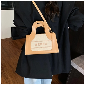 Detail of color-block canvas and leather handbag with BEPRO logo and top handle